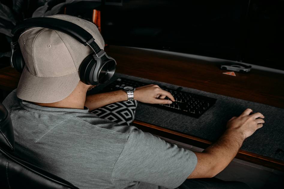Ergonomic black gaming bean bag chair with built-in speakers in a modern setup