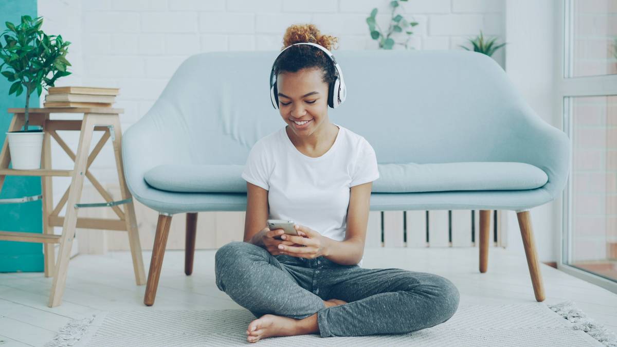 Professional gamer using customizable gaming lounge chair floor arrangement in streaming setup